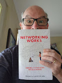 Close-up of Ron holding his book Networking Works